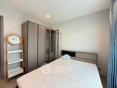 Spacious bedroom with modern wardrobe and cozy bed in a bright apartment.