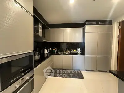 Modern kitchen with sleek cabinetry and built-in appliances in luxury apartment