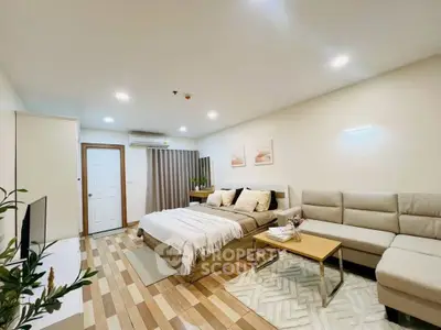 Modern studio apartment with cozy living area and stylish decor