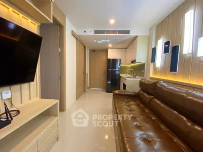 Modern living room with leather sofa and sleek kitchen in open layout apartment