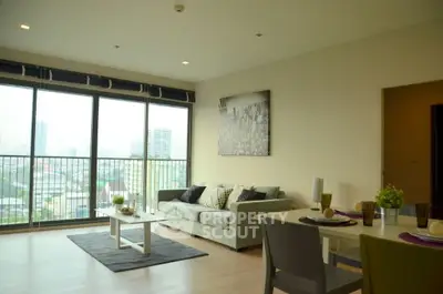 Spacious modern living room with large windows and city view, perfect for urban living.