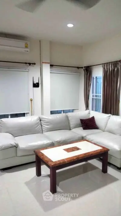 Spacious living room with white sectional sofa and modern decor