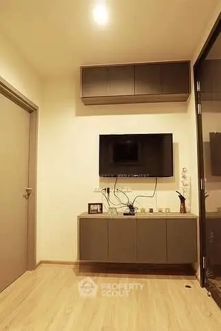 Modern living room with wall-mounted TV and sleek cabinetry