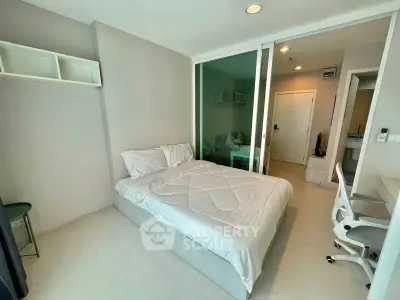 Modern bedroom with minimalist design and glass partition in a stylish apartment.