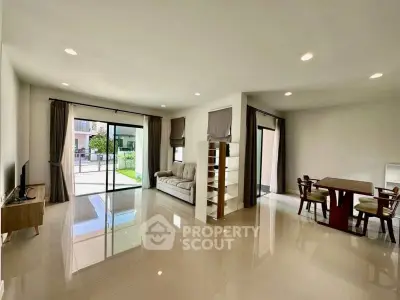 Spacious modern living room with open dining area and large windows