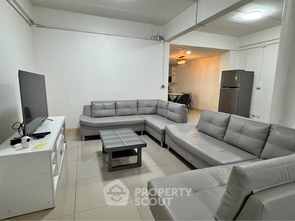Spacious living room with modern gray sofas and sleek TV setup