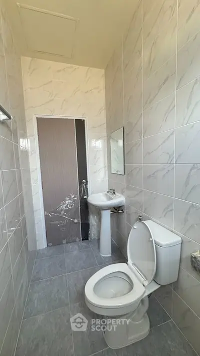 Modern bathroom with sleek tiles and compact design