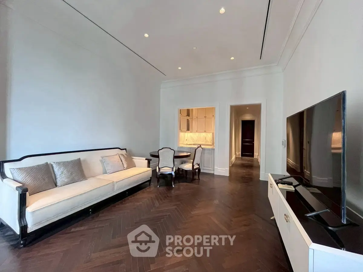 Elegant living room with dark wood flooring and modern furniture in a luxury apartment.