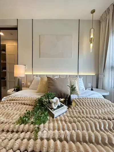 Luxurious bedroom with elegant decor and plush bedding, featuring modern lighting and stylish accents.