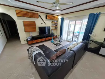 Spacious living room with modern decor and large windows for natural light.