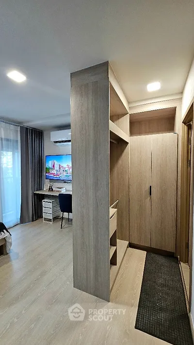Modern apartment interior with stylish wooden cabinetry and cozy living area
