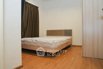 Cozy bedroom with wooden flooring and modern bed frame