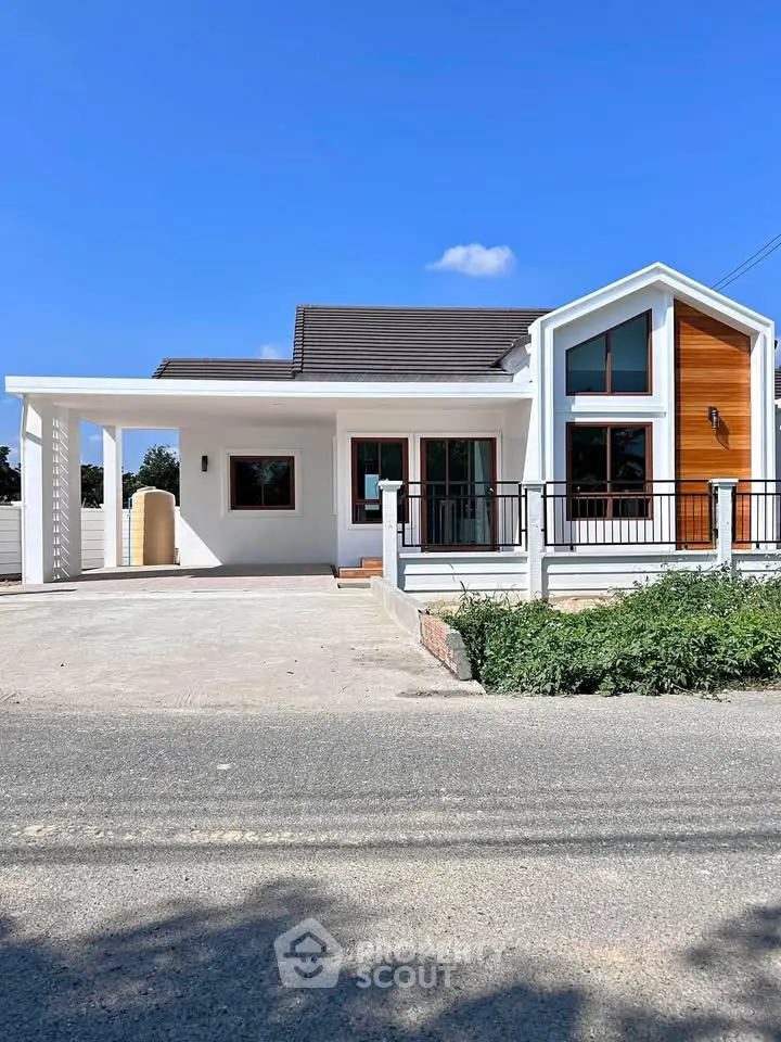 Charming modern house with unique architectural design and spacious driveway.