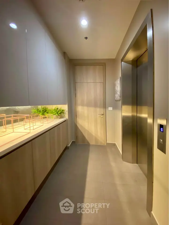 Modern elevator lobby with sleek design and ambient lighting