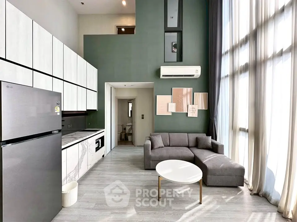 Modern loft apartment with high ceilings, large windows, and stylish open kitchen.