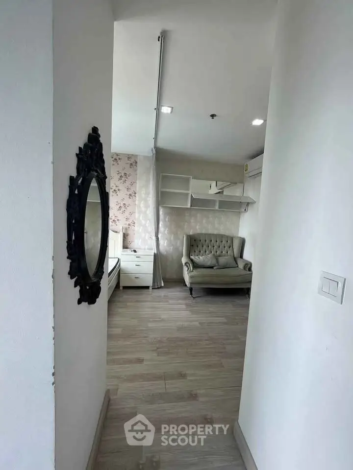 Charming interior with elegant sofa and floral wallpaper, perfect for cozy living.