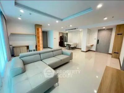 Spacious modern living room with sleek furniture and open layout in a luxury apartment.
