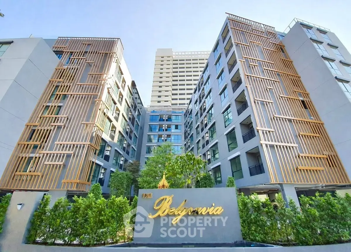 Modern apartment building with unique facade design and lush greenery