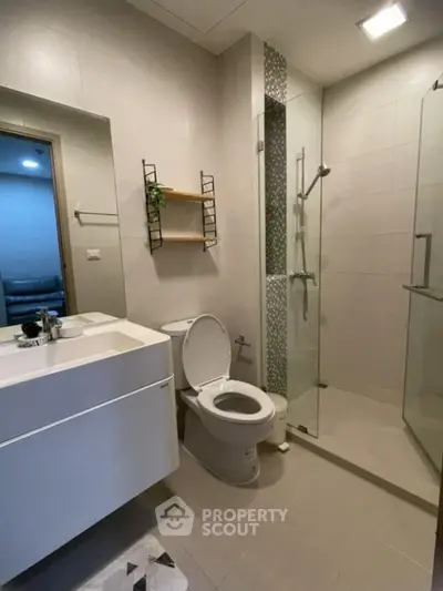 Modern bathroom with sleek fixtures and glass shower enclosure