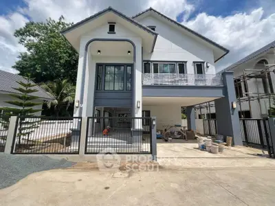 Modern two-story house with spacious driveway and contemporary design.