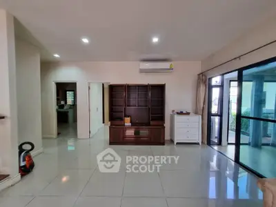 Spacious living room with modern furnishings and large windows for natural light.