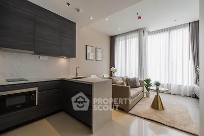 Modern open-layout kitchen and living room with sleek design and natural light