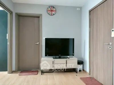 Modern living room with TV and stylish decor in a cozy apartment.