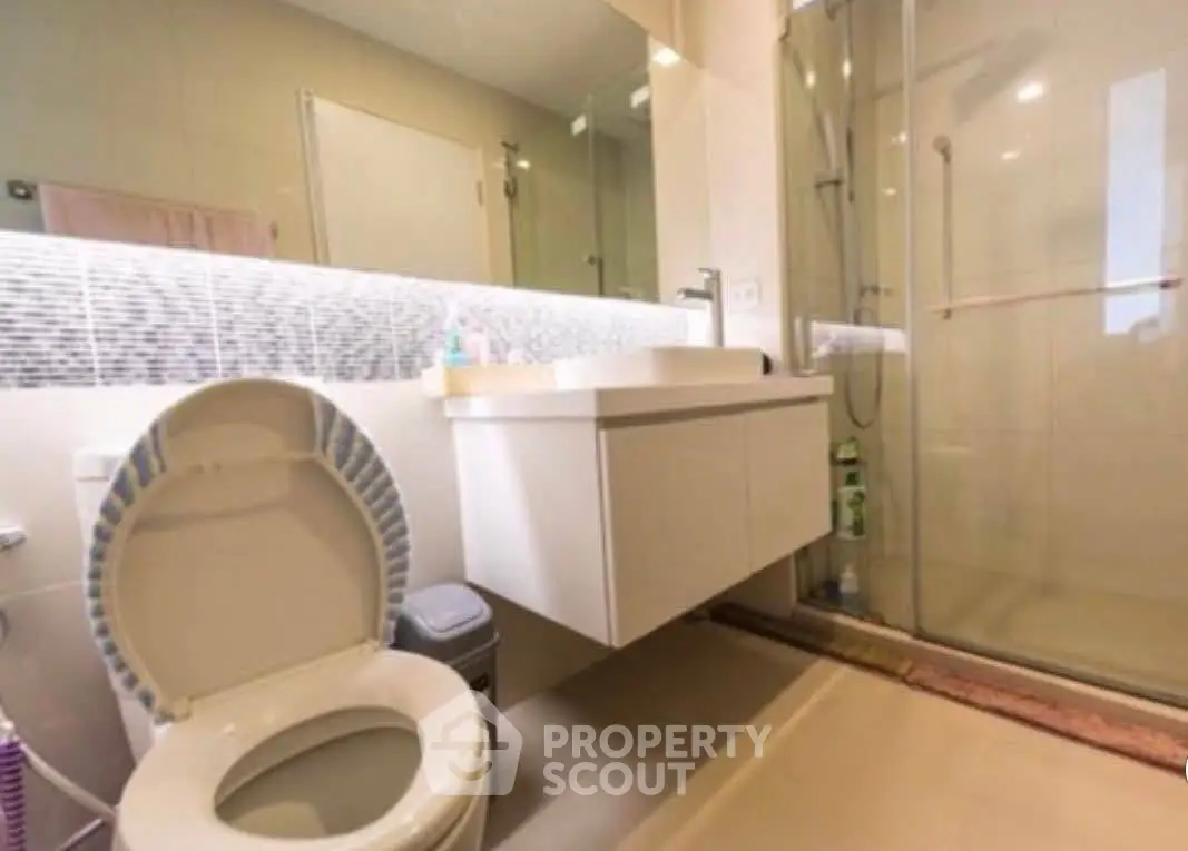 Modern bathroom with sleek fixtures and glass shower enclosure