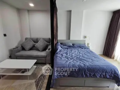 Modern studio apartment with cozy bed and stylish living area