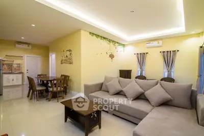Spacious living room with modern decor and dining area, perfect for family gatherings.