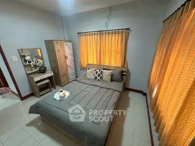 Cozy bedroom with stylish decor and ample natural light