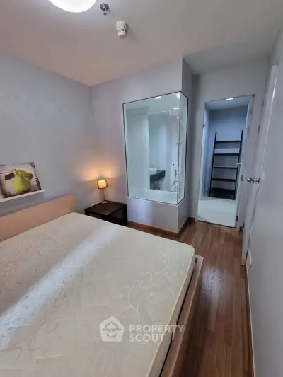 Cozy bedroom with wooden flooring and modern decor in a stylish apartment