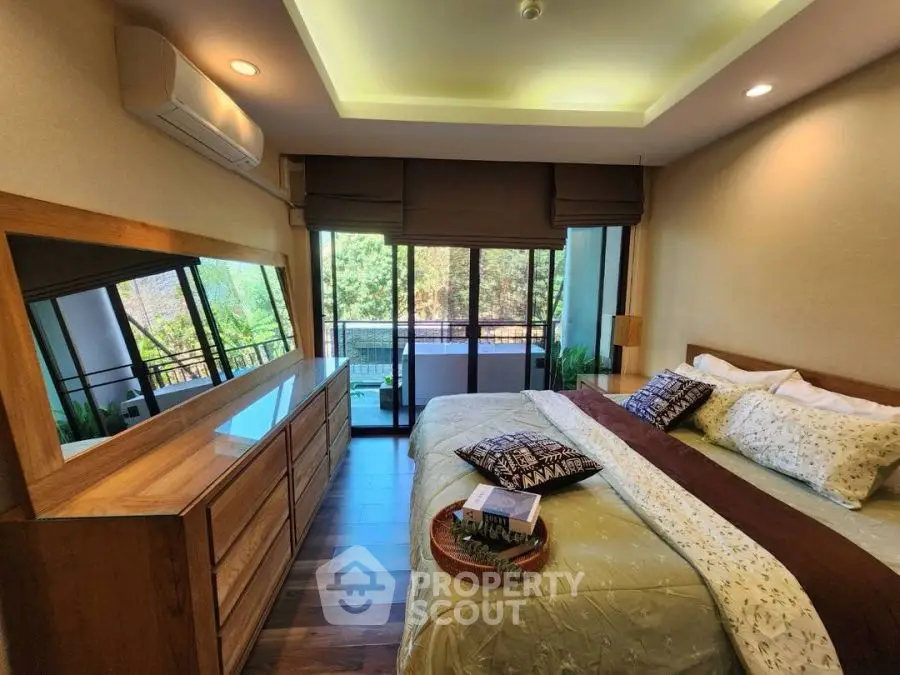 Luxurious bedroom with balcony view, elegant decor, and natural light.