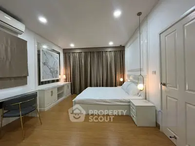 Spacious modern bedroom with elegant decor and ambient lighting