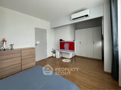 Modern bedroom with sleek furniture and air conditioning unit
