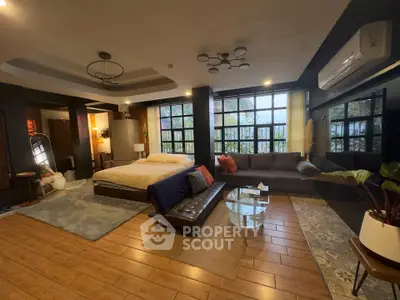 Luxurious modern living room with stylish decor, large windows, and cozy seating area.
