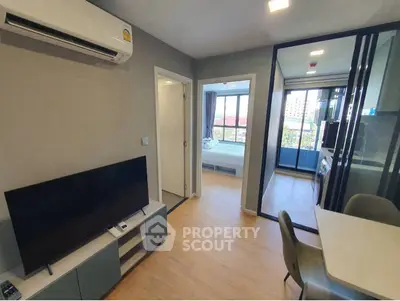 Modern apartment interior with living room, dining area, and bedroom view.