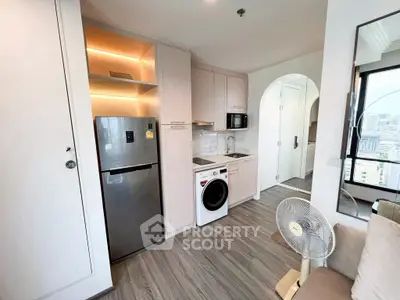 Modern compact kitchen with appliances in stylish apartment