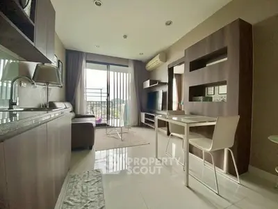 Modern living room with sleek furniture and large windows offering natural light.