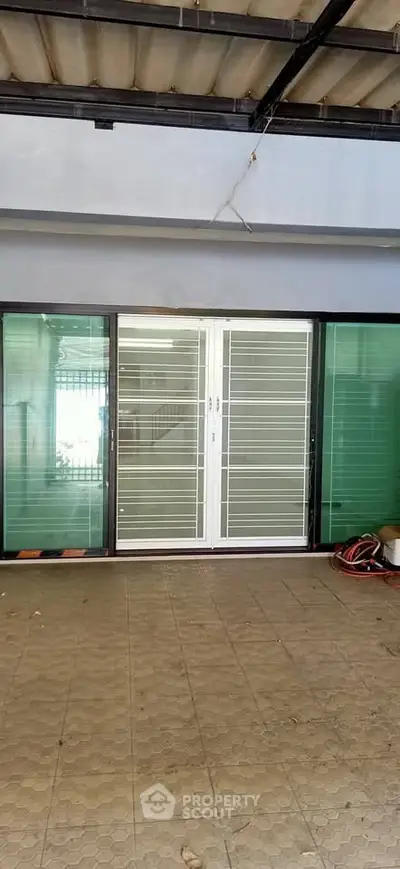 Spacious garage with sliding glass doors and tiled flooring