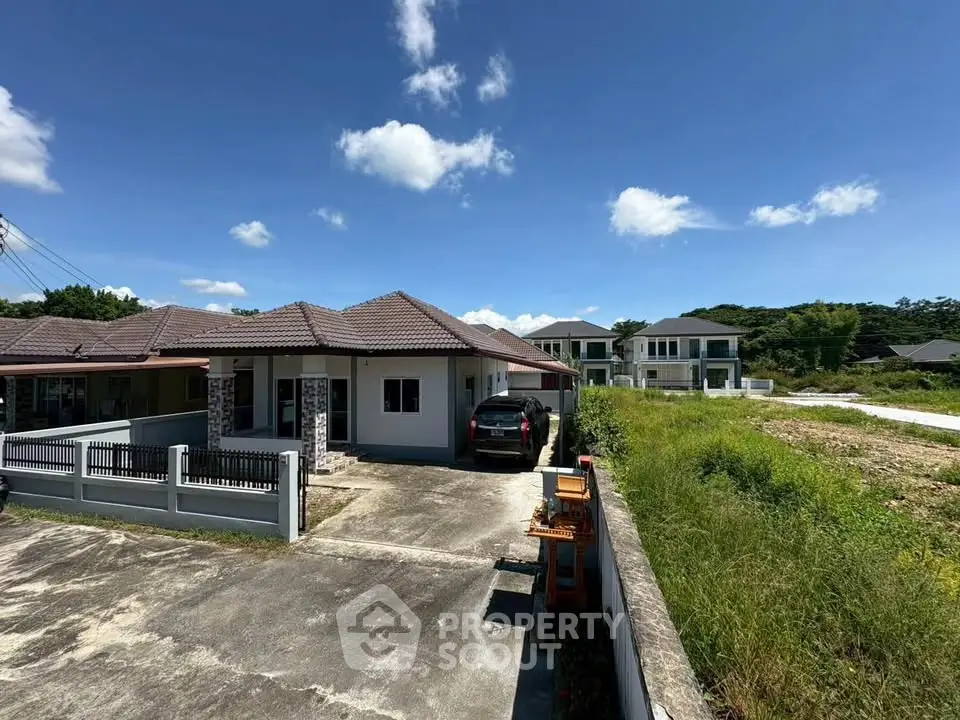 Charming suburban home with spacious driveway and lush greenery, perfect for family living.