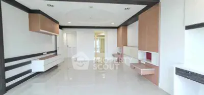 Spacious modern living room with sleek built-in storage and elegant design.