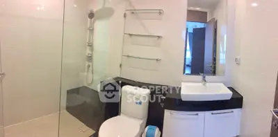 Modern bathroom with glass shower and sleek fixtures in contemporary apartment