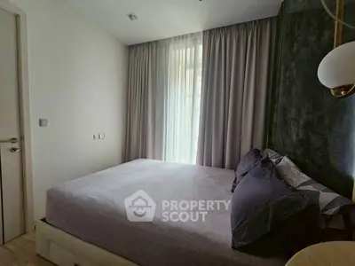 Cozy bedroom with modern decor and soft lighting, featuring a comfortable bed and elegant curtains.