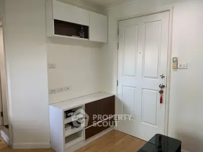 Modern apartment entrance with stylish storage and white door