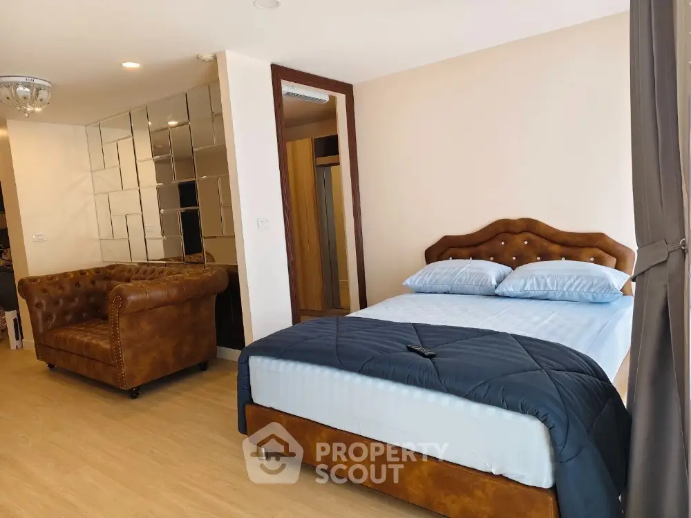 Spacious bedroom with elegant decor and plush furnishings in modern apartment
