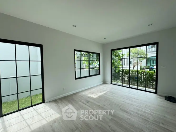 Spacious modern living room with large windows and natural light