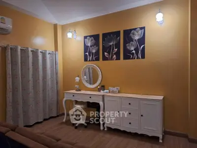 Charming bedroom with elegant vanity and floral decor, perfect for a cozy and stylish living space.