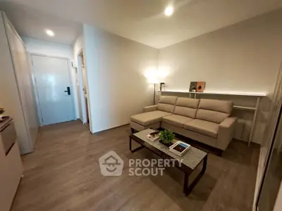 Modern living room with sleek furniture and ambient lighting in a stylish apartment.