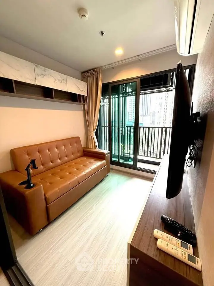 Modern living room with leather sofa and balcony view in urban apartment